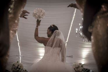 Bride throwing bouquet at a wedding